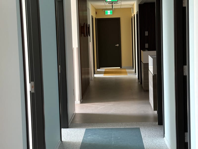 Modern office hallway with emergency exit signs